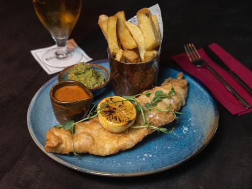 a blue plate of food with fish and french fries at Seagoe Hotel in Portadown