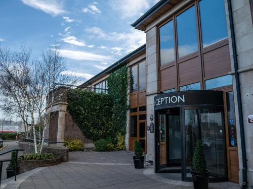 an entrance to a building with a sign on it at Seagoe Hotel in Portadown