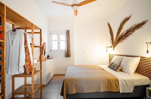 a bedroom with a bed and a dresser in it at Azula Luxury Apartments in Parikia