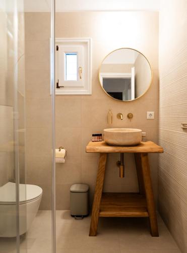 a bathroom with a sink and a mirror at Azula Luxury Apartments in Parikia