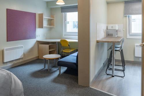 a small room with a kitchen and a table and chairs at Ensuite Bedrooms with Shared Kitchen and Studios at The Heights in Birmingham in Birmingham