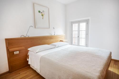 a bedroom with a large bed and a window at Locanda Osteria La Fefa in Finale Emilia