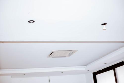 a white ceiling with a vent in a room at Guest House Auasblick by State House in Windhoek