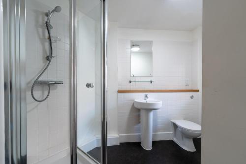 a bathroom with a toilet and a sink and a shower at For Students Only Ensuite Bedrooms with Shared Kitchen and Studios at The Old Fire Station in Birmingham in Birmingham