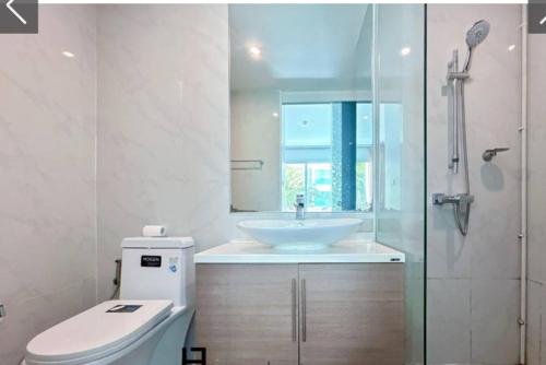 a white bathroom with a sink and a toilet at My Resort Huahin C 202 โปรโมชั่นถูกที่สุด ห้องคุณโจ in Hua Hin