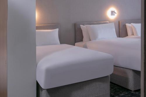 two beds sitting next to each other in a room at Best Western Appleby Park Hotel in Tamworth