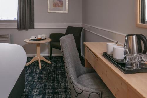 a hotel room with a table and chairs at Best Western Appleby Park Hotel in Tamworth