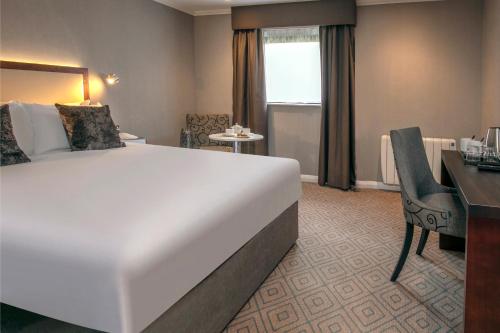 a hotel room with a large bed and a desk at Best Western Appleby Park Hotel in Tamworth