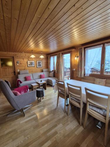 a living room with a large table and chairs at Taubenhaus OG in Fiesch