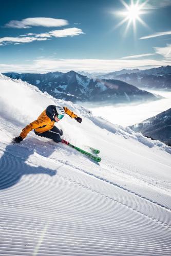 a person is skiing down a snow covered slope at Villa Frieda mit Zell am See-Kaprun Summer Card in Zell am See