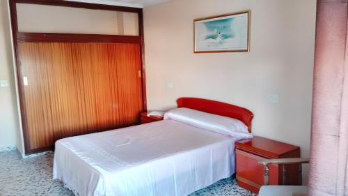 a small bedroom with a bed and a door at 2 bedrooms apartement with city view and furnished balcony at Guardamar del Segura 1 km away from the beach in Guardamar del Segura
