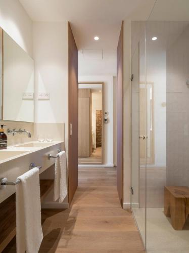 a bathroom with a sink and a glass shower at Es Figueral Nou Hotel Rural & Spa - Adults Only - Over 12 in Montuiri