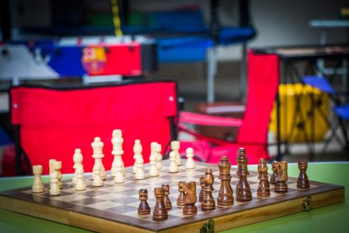 a chess board with chess pieces on a table at juSTa Birding Resort & Spa - Best Dhauladhar View Resort in Dharamshala