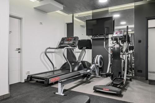 a gym with a treadmill and a flat screen tv at Villa Nani in Podstrana