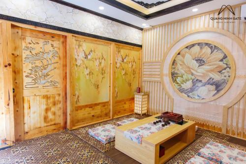 a room with wooden walls and a painting on the wall at Quảng Ninh Gate Hotel & Resort in Bác Mã