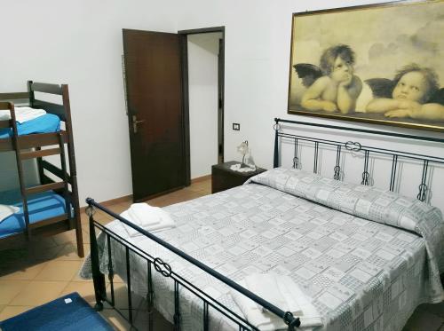 a bedroom with a bed and a painting of two babies at One bedroom apartement at Mazara del Vallo 500 m away from the beach with enclosed garden in Mazara del Vallo