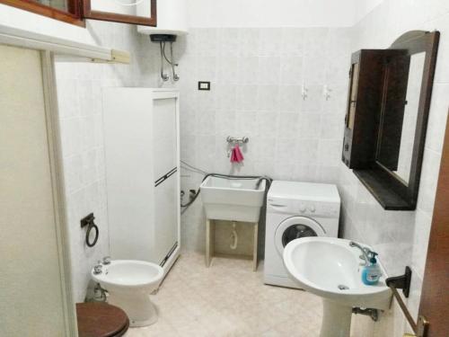a small bathroom with a sink and a washing machine at One bedroom apartement at Mazara del Vallo 500 m away from the beach with enclosed garden in Mazara del Vallo