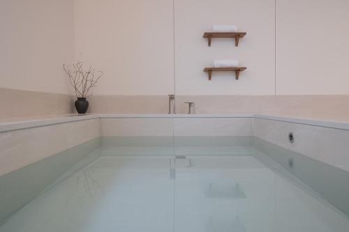 a white kitchen with a sink and a glass floor at Aank Hotel Cheonan Station 2nd in Cheonan