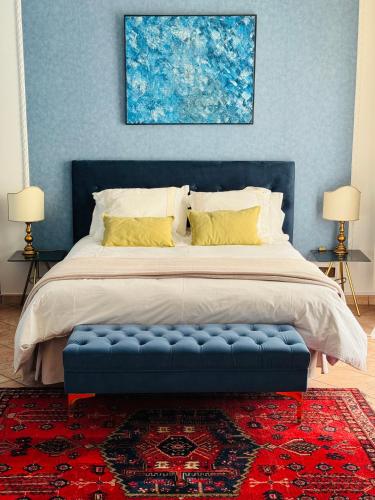 a bedroom with a large bed with a blue headboard at Gio Country House in Nicosia