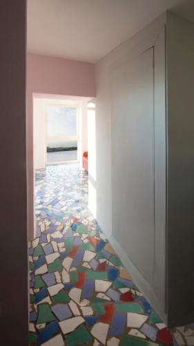 a room with a mosaic floor with a window at Casa Tiberius Capri Retreat in Capri
