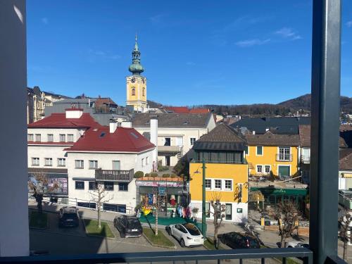 a view of a city with a clock tower at CityLake G23 Apartments in Gmunden