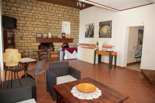 a living room with a table and chairs and a fireplace at Residence Casale Verderame in Trapani