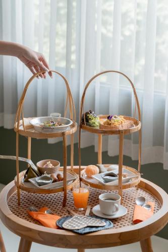 a tray of food on a table with two tiers of food at HOTEL NUU CHIANG MAI in Chiang Mai