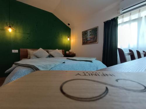Postel nebo postele na pokoji v ubytování Pansion Infinity