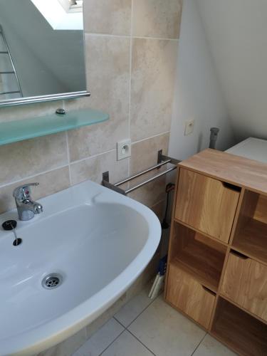 a bathroom with a white sink and a mirror at Holiday Home Nieuwendamme in Nieuwpoort