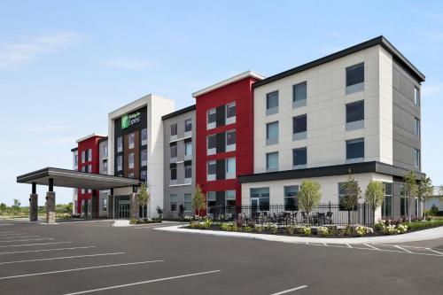 a rendering of an apartment building with a parking lot at Holiday Inn Express - Strathroy by IHG in Strathroy