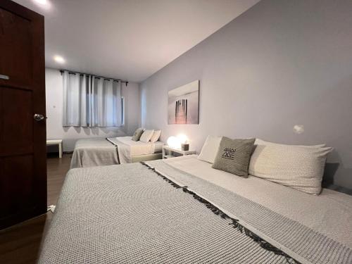 a bedroom with two beds in a room at Mini-ME Home, A Cozy Entire House in Old City in Chiang Mai