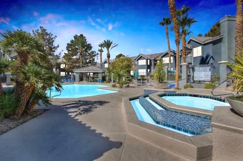 a swimming pool in a resort with palm trees at Las Vegas Apartment near the strip in Las Vegas