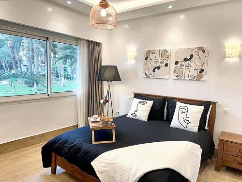 a bedroom with a large bed and a window at Comfortable Apartment with Pool in Agadir in Agadir