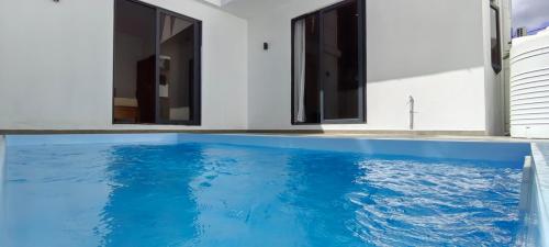 a swimming pool with blue water in a house at Garuda Villa in Trou aux Biches