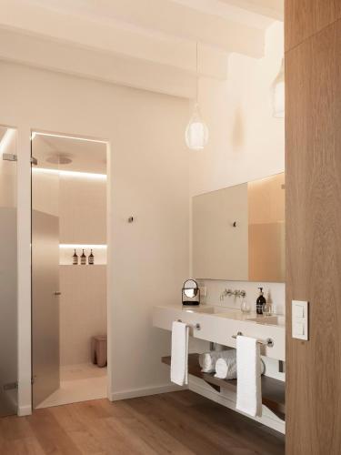 a bathroom with a sink and a mirror at Es Figueral Nou Hotel Rural & Spa - Adults Only - Over 12 in Montuiri