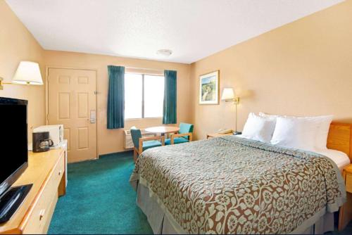a hotel room with a bed and a television at Days Inn by Wyndham El Paso Airport East in El Paso