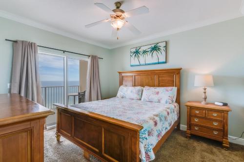 a bedroom with a bed and a dresser and a window at Crystal Shores West 202 in Gulf Shores