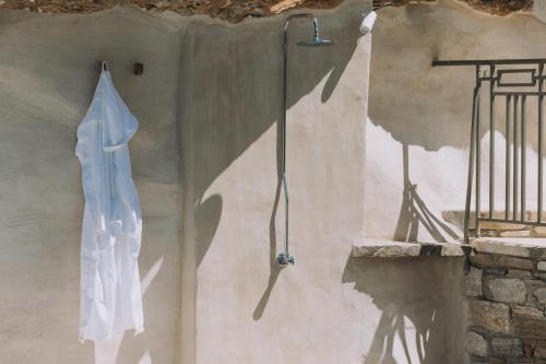 a white robe hanging on the wall of a building at Zos Suites in Kanakis