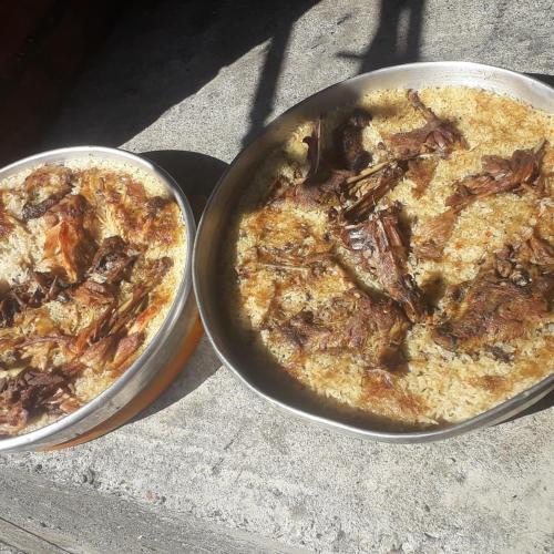 two pans of pizza sitting on top of a table at Camping Lisna in Vau i Dejës