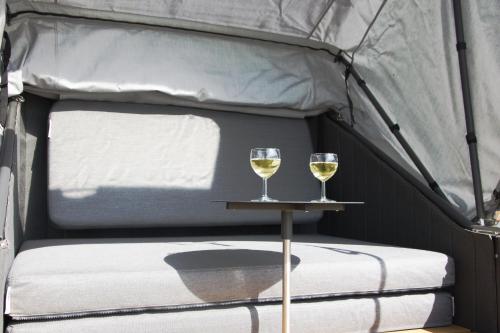 due bicchieri di vino su un tavolo in una tenda di Schlafstrandkorb a Südbrookmerland