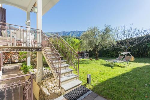 a staircase leading up to a house with a yard at Villa Ida - Private Gym & SPA - by Rent All Como in Lenno