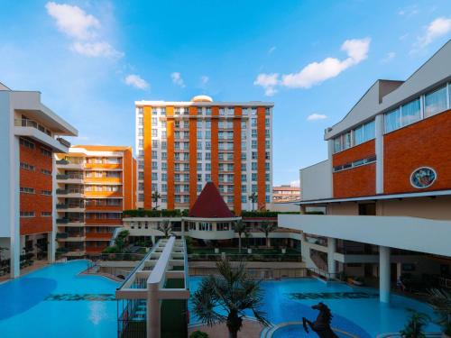 a view of a city with a large building at Mövenpick Hotel & Residences Nairobi in Nairobi