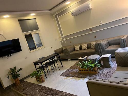 een woonkamer met een bank en een tafel bij شاليهات توليب in Al Falt
