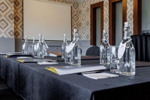 a table with glass bottles on top of it at Hotel Cristal Park in Dąbrowa Tarnowska