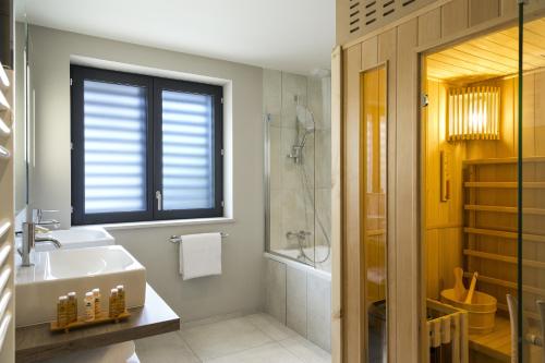 a bathroom with a sink and a toilet and a shower at Appartements de l'Héliopic in Chamonix-Mont-Blanc