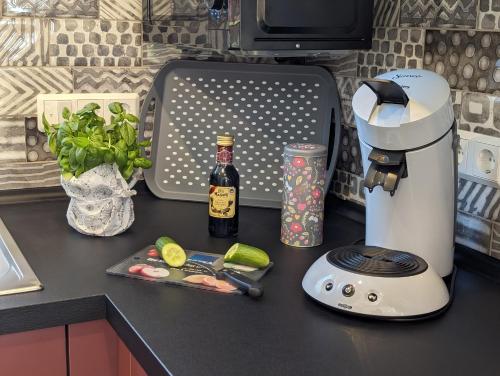 a kitchen counter with a mixer and a bottle of wine at Premiumferienhaus Mara in Hasselfelde