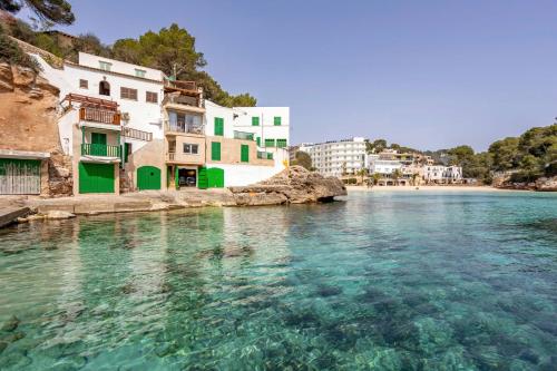 a view of a body of water with buildings at Chalet Cal Tio Miquel by dracmallorca in Cala Santanyi