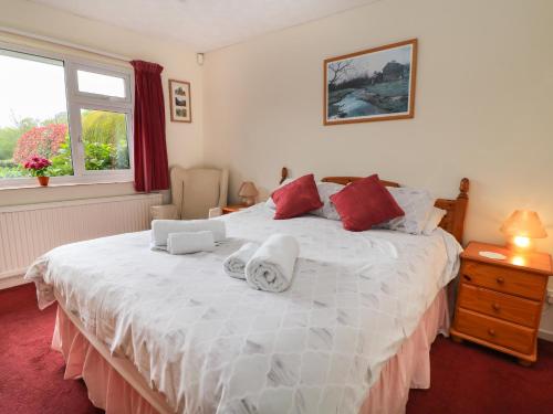 a bedroom with a large bed with towels on it at Plummers Water in Lymington