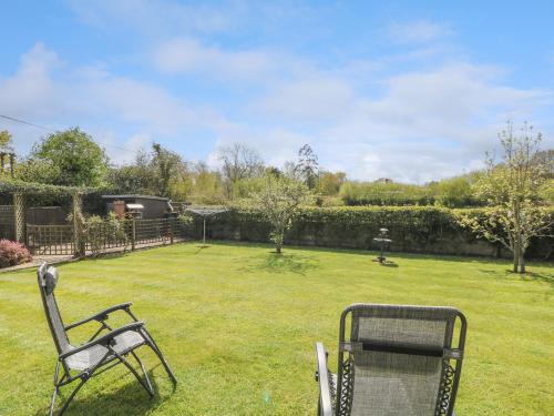 a chair sitting in the grass in a yard at Plummers Water in Lymington