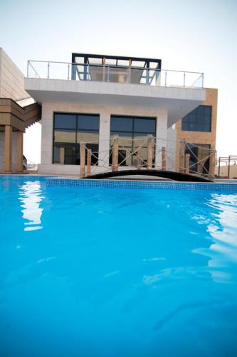 a house with a swimming pool in front of it at Casa Élan for VIP guests 2 Pools in Ras al Khaimah